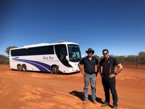 bus and two people in desert