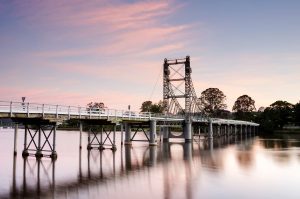 Bridge over river at sunset