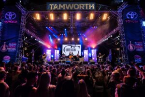 Crowd or people watching musicians performing on stage